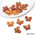 Macro detail of amber butterfly acrylic beads with gold edges for DIY jewelry 20x17mm - 20x17mm / Butterfly Design / 15 Pcs Pack / Amber