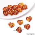 Close-up of 15x13mm amber acrylic heart beads with gold-rimmed center for DIY jewelry - Heart Shape