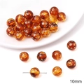 Detailed macro of 10mm amber acrylic beads with gold stars for DIY jewelry - Star Round Shape
