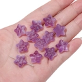 Detailed view of purple star-shaped glass beads for handmade jewelry on a palm - 10 Pieces/Pack (15x14mm) / Gradient Purple