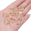 Macro detail of transparent star-shaped glass beads with gold foil foil in hand - 10 Pieces/Pack (15x14mm) / Light Yellow