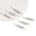 Macro view of five silver alloy fishbone charms for DIY handmade jewelry crafting - White Gold