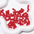 Red bamboo-shaped glass beads for DIY necklaces displayed on a white ceramic flower tray - Red