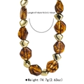 Chunky necklace detail showing amber marble beads and golden geometric metallic accents - Necklace / Amber