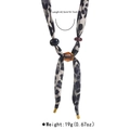 Detailed view of leopard print scarf necklace with size specs: 42.5cm long and 19g weight - Black