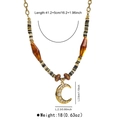 Detail view of vintage beaded necklace with moon pendant and dimension measurements - Moon
