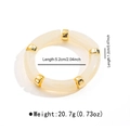 Detalle de la pulsera elástica de resina crema con espaciadores dorados y dimensiones clave - Estilo Tubo Elástico con Cuentas (B3453)
