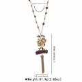 Detail view of vintage geometric tassel necklace with beaded chain and golden bird pendant - Antique Gold and Silver