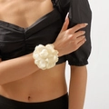 Close-up of elegant cream satin rose bracelet on model's wrist with soft lighting - Cream Satin 3D Flower Tie Style (B2020) / Cream