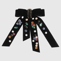 Macro detail of black velvet bow hair clip with colorful rhinestones and pearls - Black