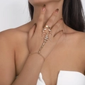 Macro detail of a golden scorpion hand harness with sparkling crystals on a woman's hand - Gold Scorpion