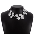 Macro view of metallic silver leaf branch necklace with detailed texture on neck model - Silver Leaf Vein Texture Leaf Necklace (N10856)