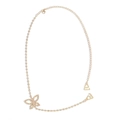 Detailed macro shot of a golden butterfly body chain with sparkling white rhinestones - Butterfly Design / Gold