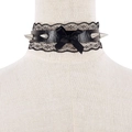 Close-up of black lace punk choker with metal spikes and ribbon bow on display - Black