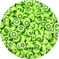 Macro detail of round light green acrylic beads with black star and moon symbols - 100pcs Pack / Green