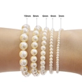 Handmade high-gloss glass pearl bracelets set showing 3mm to 10mm sizes on wrist - Size C / Off White