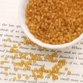 Frosted amber glass seed beads 2mm for DIY jewelry making displayed in a white ceramic bowl - 3mm 20g/Pack Approx 700 Pcs / Brown