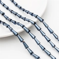 Detail of dark grey faceted cone glass beads with metallic luster for DIY jewelry - 7x4mm (68 Pieces/Pack) / Hematite Color