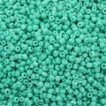 Flat lay of opaque mint green glass seed beads for DIY jewelry and handicraft making - Teal