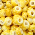 Flat lay of yellow and white marble pattern acrylic beads for DIY jewelry making - 30 Pieces/Pack (15x9mm, 6mm Hole) / Yellow