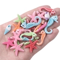 Macro view of colorful acrylic ocean animal beads held in hand for size comparison - Small Size Approx 4-27mm Random Mix (Approx 65-75 Pcs)