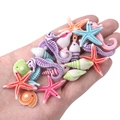 Close-up of colorful resin sea creature beads held in hand for DIY jewelry making - Large Size Approx 10-35mm Random Mix (Approx 25-35 Pcs)