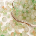 Ronde glazen kralen met groen-oranje marmerpatroon voor DIY-sieraden maken - 8mm (50 stuks) / Lichtgroen met oranje stippen (nr. 16)