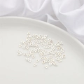 Silver triangle spacer beads for DIY jewelry making displayed on a white silk base - Middle Hole Triangle 3.5x1.5mm (Aperture 1.3mm) 10 Pieces/Pack / Thick Silver Plated