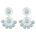 Detail of vintage silver earrings featuring hammered metal texture and turquoise stones - E11349
