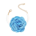 Detail of blue fabric rose bracelet featuring white round pearls and gold lobster clasp - Blue