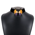 Detail of velvet choker featuring symmetrical orange and purple enamel flower petals - Black Orange Purple
