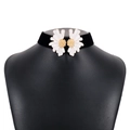 Close-up of black velvet choker featuring two white daisy flowers with gold centers - White