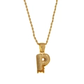 Macro detail of iced out letter P pendant with red dripping zircon on gold rope chain - Letter P