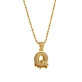 Detail of gold lava style letter Q necklace with white zircons and orange drip effect - Letter Q