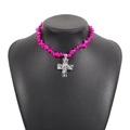 Macro detail of fuchsia stone beads and vintage silver cross pendant on a necklace - Rose Red