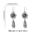 Detail showing vintage silver earrings with floral engraving and turquoise stones - E12734
