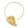 Detailed view of a gold-plated calla lily pendant with hammered texture on a rigid choker - Gold