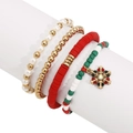 Detalle de set de pulseras navideñas con dije de copo de nieve y cuentas festivas - Copo de nieve