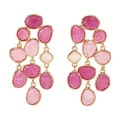 Close-up of bohemian tassel earrings with pink resin stones in gold metal settings - Rose Red