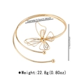 Macro view of gold butterfly upper arm cuff with 8.5cm diameter and wired wing detail - Butterfly