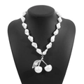 Detailed view of Baroque pearl cherry pendant necklace with silver metal leaves on neck display - Necklace (N12619) / Silver