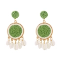 Detail of colorful raffia earrings with green woven balls and natural white shells - Green