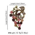 Vista macro dettagliata di una spilla vintage a forma di uva con cristalli e strass - Forma di Uva Oro Vintage / Zircone Colorato