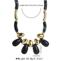 Detailed view of vintage chunky acrylic beaded necklace with gold and black marble pendants - Black