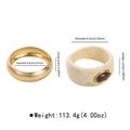 Golden metal bangle set with marbled resin cuff featuring a brown oval gemstone inlay - Gold