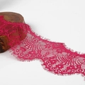 Detail of fuchsia embroidered eyelash lace trim with floral patterns on wood base - Rose Red
