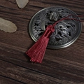 Elegant dark red handmade silk tassel displayed on a vintage bronze dragon pattern lid - Burgundy