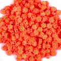 Detailed macro of orange clay flower beads with black smiley faces and side holes - Plum Flower Smiley (4873383871405)