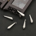 Close-up of five silver-toned teardrop charms with embossed dot patterns and top loops - White K Color 8x31 20 Pieces/pack