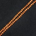 Polished orange cat eye stone round beads for DIY jewelry making on a dark background - Orange